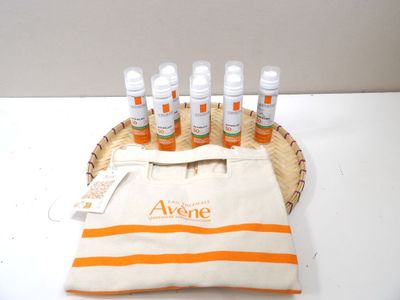 six bottles of perfume sitting on a basket with a bag