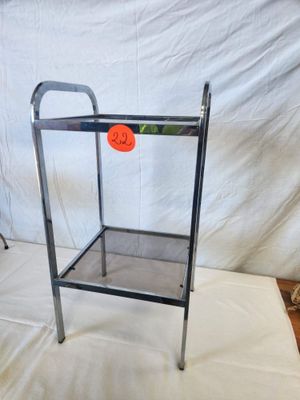a metal stand with an orange ball on it