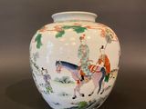 a white vase with a picture of a man riding a horse