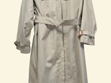 beige trench coat on a hanger on a white background