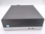 the hp desktop computer is sitting on a white surface