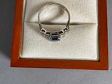 a ring in a box that has a diamond on it
