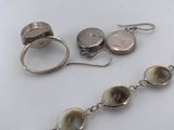 a close up of a pair of earrings and a ring