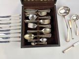 a wooden box with silverware in it on a table