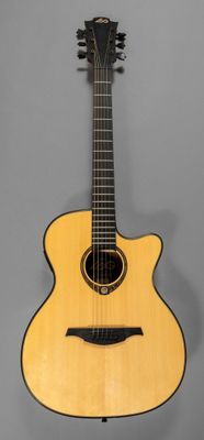 an acoustic guitar hanging on a wall