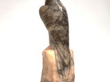 marble statue of a hawk sitting on a rock on a white background