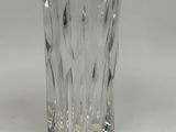 a clear glass with a pattern on it on a white surface