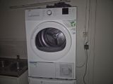 un lave-linge et un sèche-linge blancs dans une petite pièce