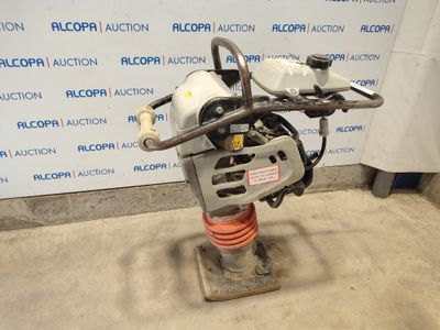 a close up of a machine on a stand in front of a wall