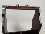 a wooden box with a metal handle on a table