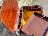 a small wooden box that is open and sitting on the ground