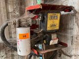 a picture of an old gas pump in the corner of a building