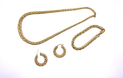 three pieces of gold jewelry on a white surface