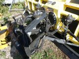 a picture of a tractor that is sitting in the grass