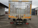 a truck with a cage on the back parked in a parking lot
