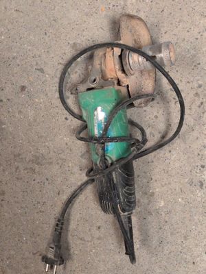 an image of a green and black drill on the ground