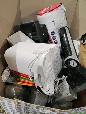 a cardboard box filled with electronics and other items