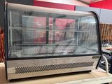 a display case with a lot of food inside of it