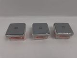 three electronic devices sitting on top of a white surface