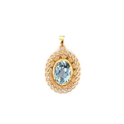 a gold pendant with a blue topaz stone in the center
