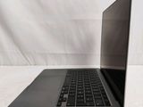 an open laptop computer sitting on top of a white table