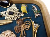 a tray that has a bunch of jewelry inside of it