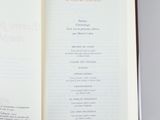 an open book with a menu in it on a table