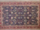 un tapis persan ancien à fond bleu et bordure rouge