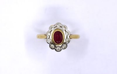 a close up of a gold ring with a red stone