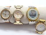 three different watches are sitting on a napkin on a white surface