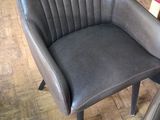 many chairs and tables in a room with wood flooring