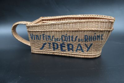 an image of a woven basket bag with a blue writing on it