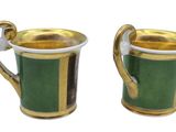 pair of green and gold mugs with handles on a white background