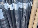 many rolls of fabric on a shelf in a store