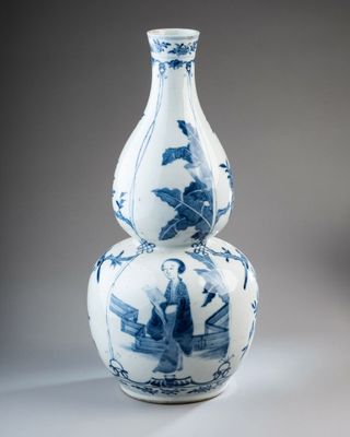 a blue and white vase sitting on top of a table