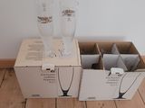 two empty wine glasses sitting in a box on the floor