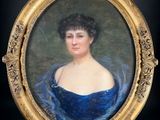portrait of a woman in a blue dress in a gold frame