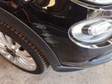 a close up of a car ' s headlight and front bumper