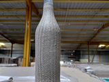 a bottle sitting on top of a table in a warehouse