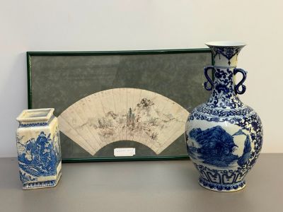 two vases and a fan on a table