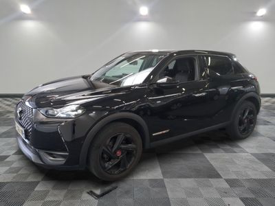 a black suv is parked on a checkered floor in a garage