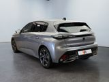 the rear view of a silver car in a showroom