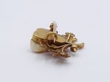 a gold plated brooch on a white surface