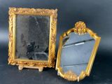 two mirrors that are sitting next to each other on a table