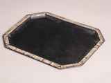 an image of a black and gold tray on a white table