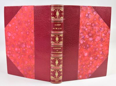 the book is red with gold trimmings and a red cover