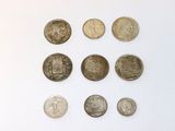 a lot of coins that are on a white surface