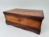 an old wooden box sitting on top of a white surface