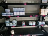 many boxes of toothpaste on the shelves in the store