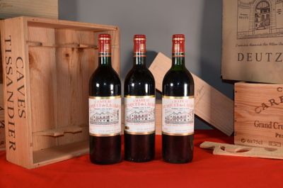 three bottles of wine sitting on a table next to a wooden box